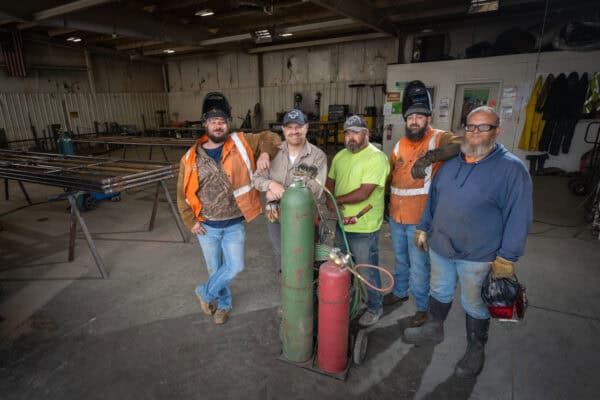 Dinklage Feedyards Maintenance Division Team in Scottsbluff Nebraska. Welding and machining ironwork careers. Photo Credit John Patrick Phelan ©️2024